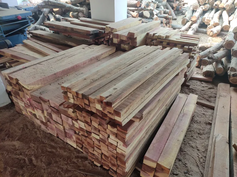 Sawn countrywood timber planks stacked and ready for cutting at the Subramaniya Sawmill & Timber Mart processing yard