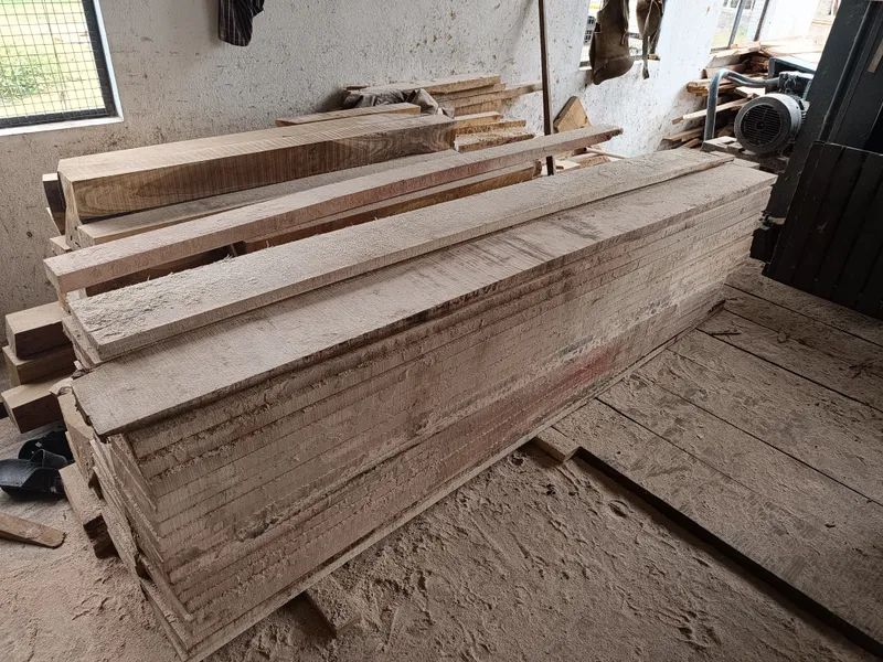 Sawn silver oak timber planks stacked inside the Subramaniya Sawmill & Timber Mart workshop, ready for quality inspection
